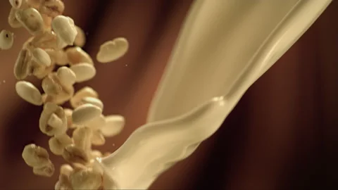 Falling flakes cereal in milk in slow motion Stock Footage 256938286