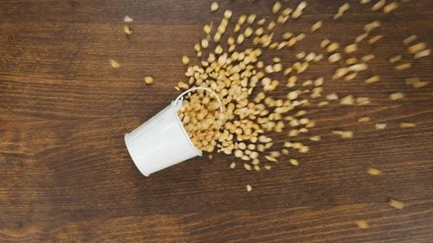 Falling of a full bucket with peas grains. Slow motion. Video stock 125910975