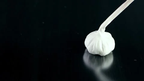  Falling garlic isolated on dark background 스톡 동영상 132910474