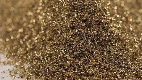 Falling glitter gold shavings,closeup dropping small chips 動画素材 72158190