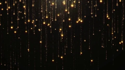 Falling gold particles flicker and shimmer against a black background. Abstract Stock Footage 75177645