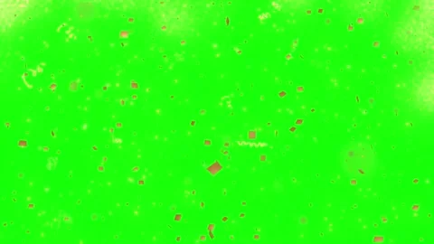 Falling golden confetti particles against a bright green screen background Видео 338314545
