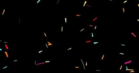 Falling golden metallic glitter foil confetti on black background, gold holiday Видео 252184181