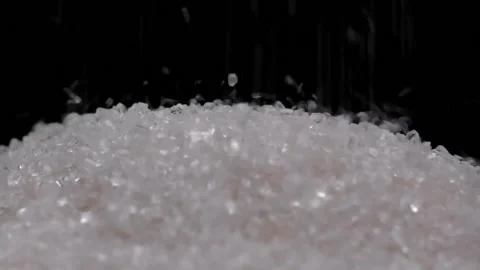 Falling grains of white sugar into the total mass of sugar. Stock Footage 170024150