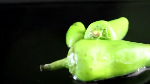 Falling green chilli pepper with water splash 스톡 동영상 136120314