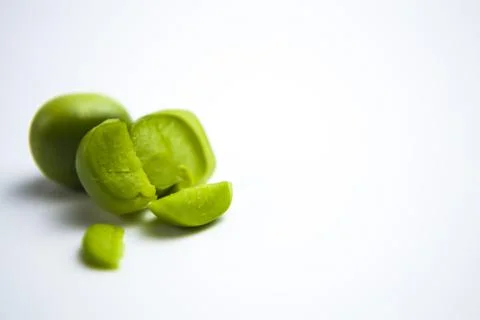 Falling green peas isolated on white background with clipping path Stock Photos