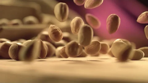 Falling hazelnuts on a kitchen surface in slow motion Stock Footage 256937364