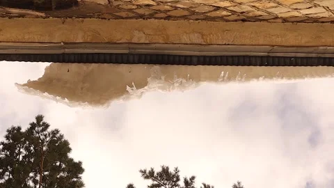 Falling Ice and Melting Icicles from Roof, Spring Thaw and Seasonal Danger Stock Footage 328016606