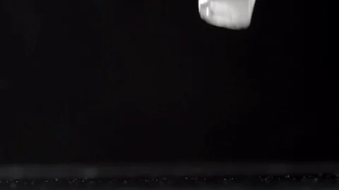 Falling ice cubes on a black background Video stock 77921568