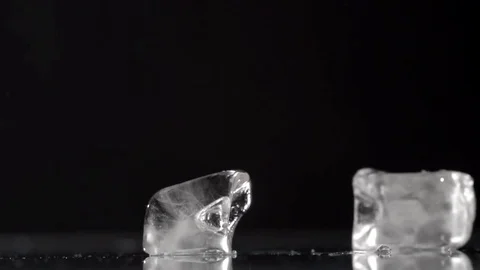 Falling ice cubes on a black background Stock Footage 77921988
