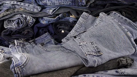 Falling jeans in slow motion on a pile of jeans Stock Footage 126160279