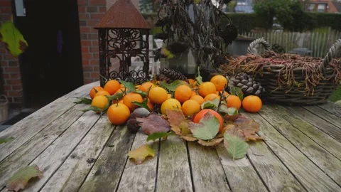 Falling leaves over orange fruit clementines 動画素材 143078446
