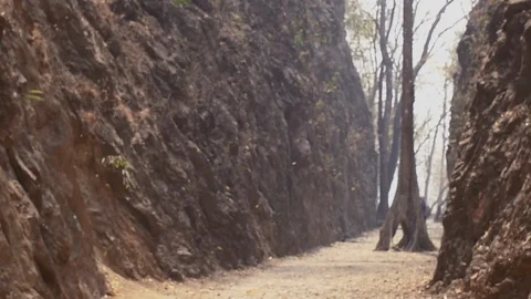 Falling leaves slow motion in Hellfire pass rock mountain and tourist start Stock Footage 103042242