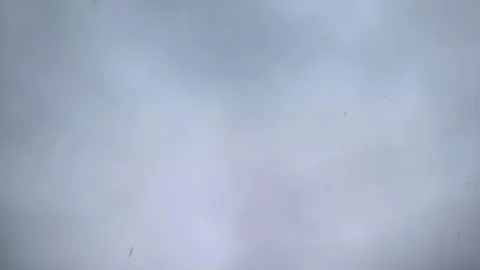 Falling on lens large snowflakes close-up. Snowfall in slow motion 動画素材 227003163