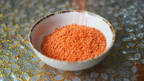 Falling lentils in a bowl Stock Footage 332688858