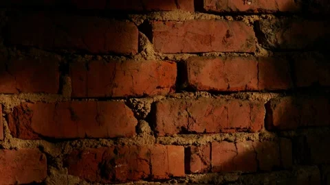 Falling light from a window moves along a brick wall, time-lapse. Video stock 152499587