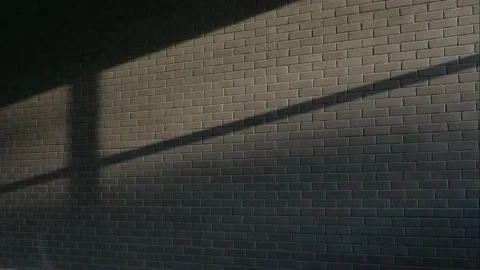 Falling light from a window moves along a brick wall, time-lapse. Stock Footage 153023568