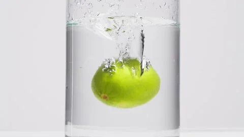 Falling a lime in the water. Stock Footage 132861210