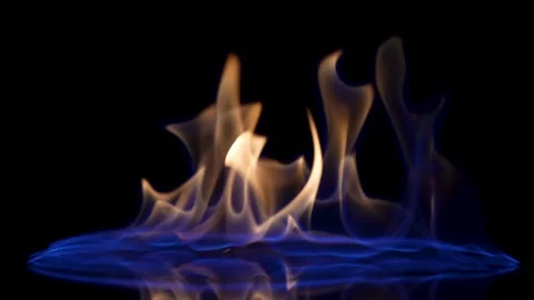 Falling match causes flames to ignite against black studio background Stock Footage