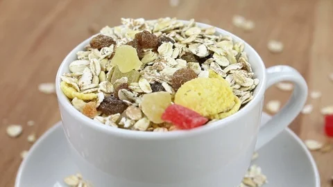 Falling muesli cereal into a white cup Video stock 74693741