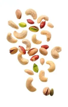 Falling nuts on white backgrounds. Stock Photos
