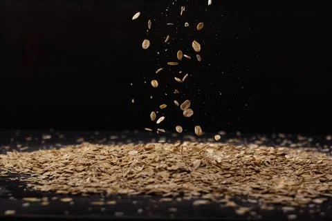 Falling oatmeal on wooden background Stock Photos