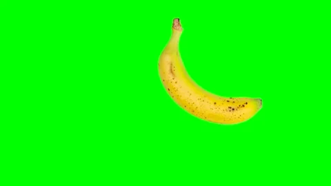 Falling or flying yellow banana on a green chromakey background Stock Footage 220940772