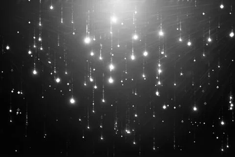 Falling particles flicker and shimmer against a black background. Abstract ba Illustrazione stock