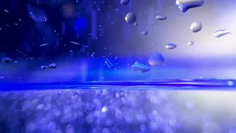 Falling particles into water Stock Footage 257476824