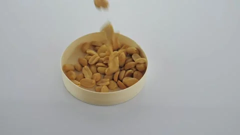 Falling peanuts, peeled and ready to eat in an organic placemat Stock Footage 151652678