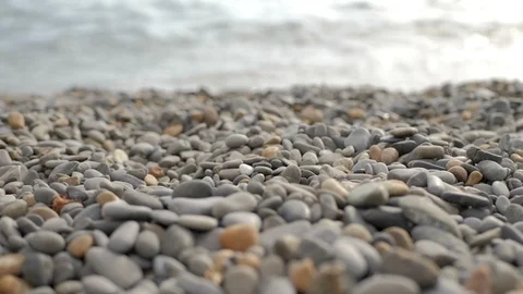 Falling pebbles on the background of the sea Stock Footage 123537092