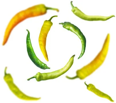 Falling pepper on a white background. Scattered pepper on a light background Stock Photos