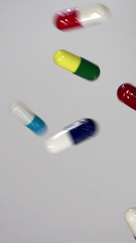 Falling Pills in Slow Motion – Vertical Healthcare Background Stock Footage 328667791