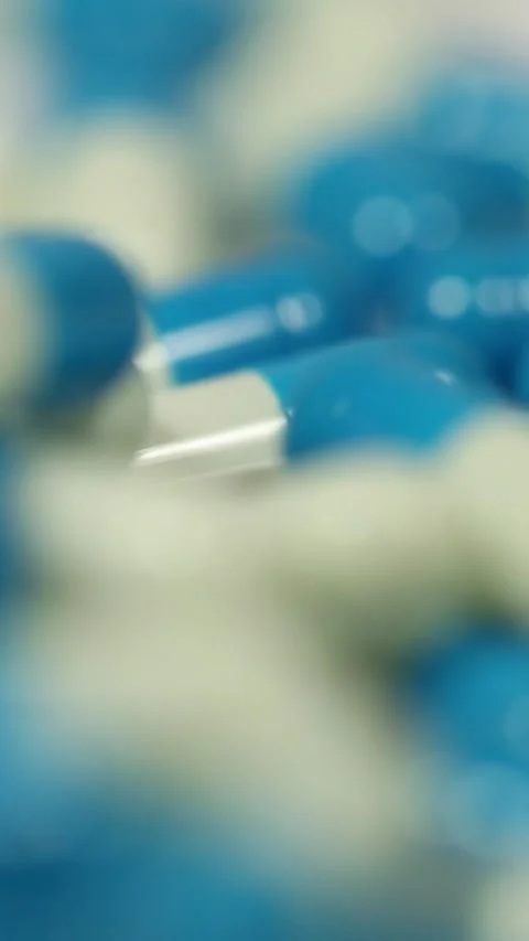 Falling Pills in Slow Motion – Vertical Healthcare Background Stock Footage 328667799