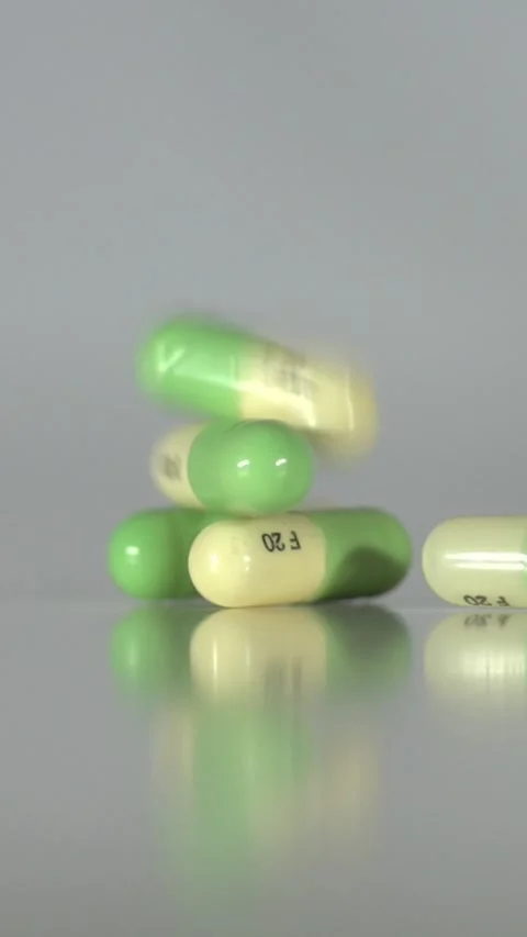 Falling Pills in Slow Motion – Vertical Healthcare Background Stock Footage 328667805