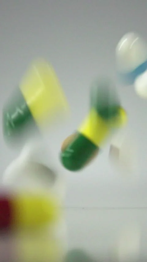 Falling Pills in Slow Motion – Vertical Healthcare Background Stock Footage 328667807