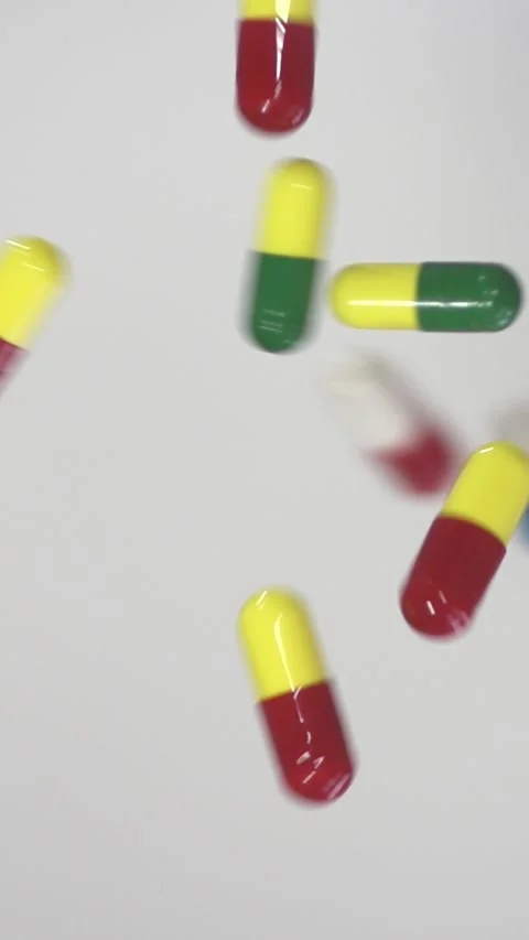 Falling Pills in Slow Motion – Vertical Healthcare Background Stock Footage 328667809