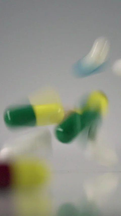 Falling Pills in Slow Motion – Vertical Healthcare Background Stock Footage 328667819