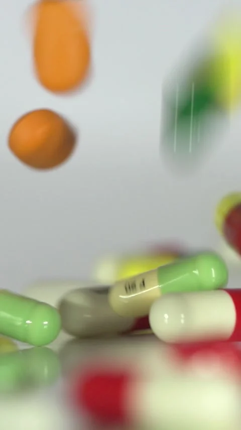 Falling Pills in Slow Motion – Vertical Healthcare Background Stock Footage 328667836