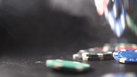 Falling poker chips hitting ground with smoke swirling and slow motion Video stock 205535672