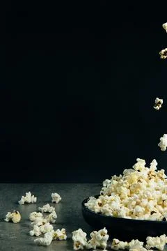 Falling pop corn on black background Stock Photos