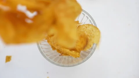 Falling Potato Chips against white bowl Stock Footage 139811948