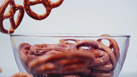 Falling Pretzels on blue background super slow motion 1000 fps Stock Footage 141054611