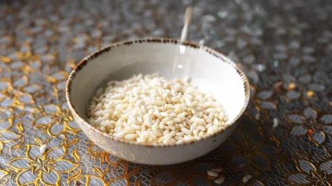 Falling puffed rice in a bowl Stock Footage 332688806