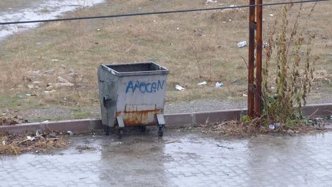 Falling rain and garbage bin on the street, Stock Footage 121889419