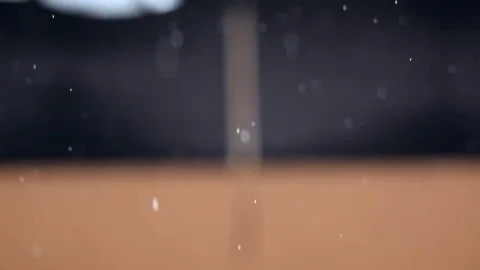 Falling rain storm, on a black and orange out of focus building background Stock Footage 78827169