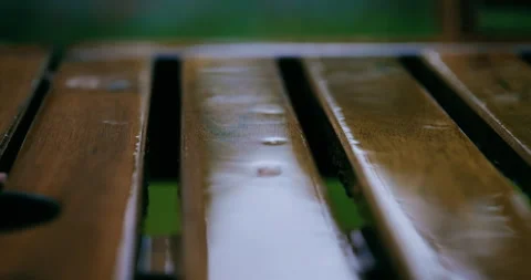 Falling rain on wooden planks. close up of rain falling on wood Stock Footage 346653486