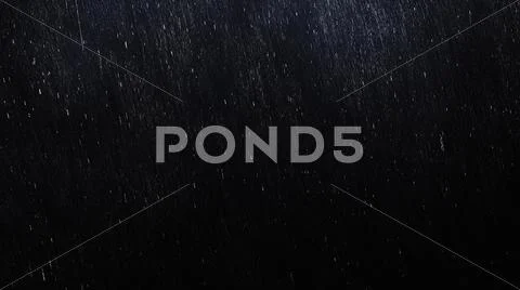 Falling raindrops in on dark background with start and end Stock Photos