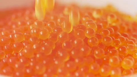 Falling red caviar closeup macro view Stock Photos