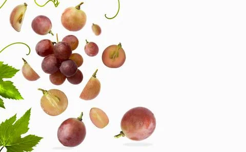Falling red grape with leaves, isolated on white background, selective focus Stock Photos